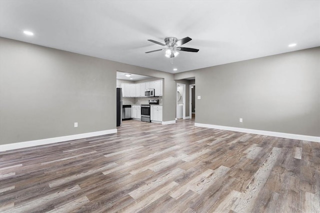 113 Brand Ave, Red Bud, IL 62278 - unfurnished living room featuring a ceiling fan, baseboards, light wood-style flooring, and recessed lighting
