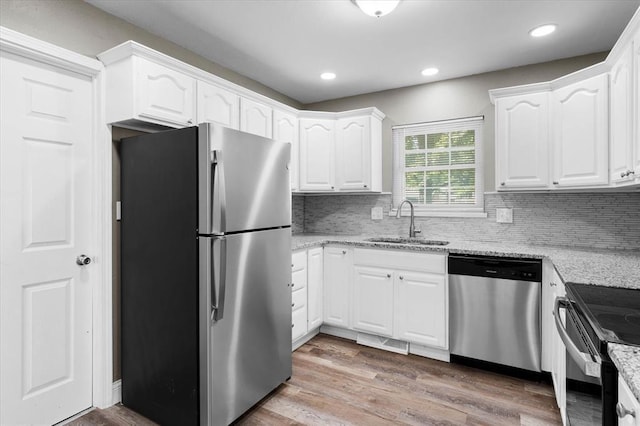 113 Brand Ave, Red Bud, IL 62278 - kitchen featuring stainless steel appliances, a sink, light stone counters, white cabinets, and recessed lighting