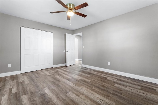 113 Brand Ave, Red Bud, IL 62278 - unfurnished bedroom with baseboards, wood finished floors, a closet, and ceiling fan