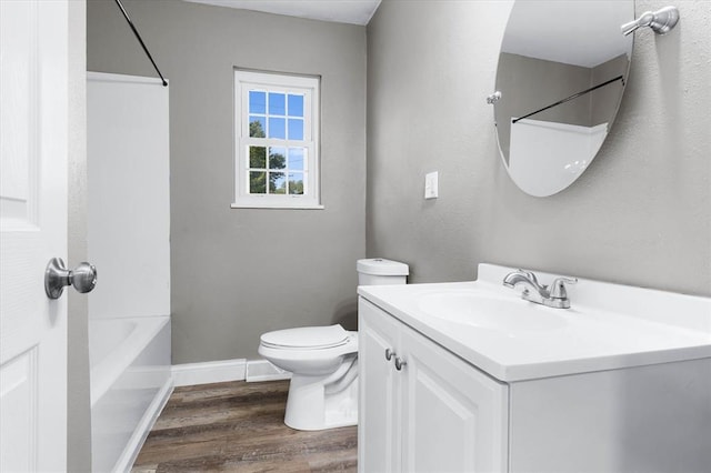 113 Brand Ave, Red Bud, IL 62278 - bathroom with vanity, wood finished floors, toilet, baseboards, and shower / bathtub combination