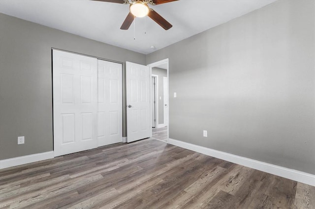 113 Brand Ave, Red Bud, IL 62278 - unfurnished bedroom with baseboards, wood finished floors, a closet, and a ceiling fan