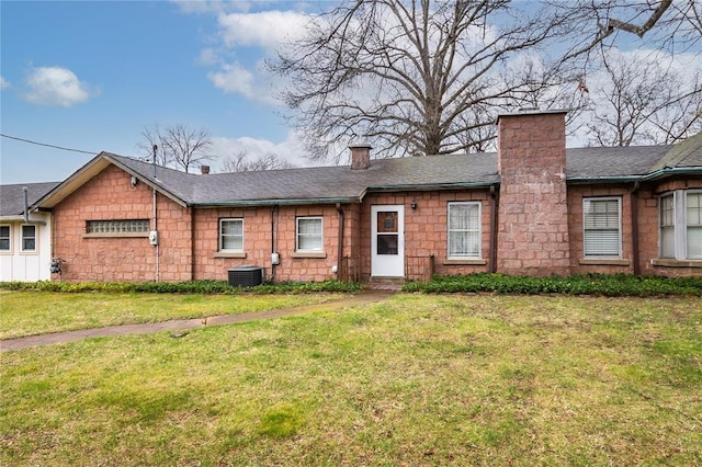 12810 Big Bend Rd, Kirkwood, MO 63122 - back of property with a chimney, central AC, a yard, and roof with shingles