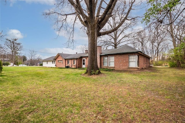 12810 Big Bend Rd, Kirkwood, MO 63122 - rear view of property featuring a chimney and a lawn