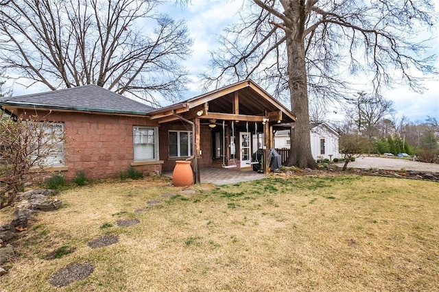12810 Big Bend Rd, Kirkwood, MO 63122 - back of property with a patio, a yard, a shingled roof, and stone siding