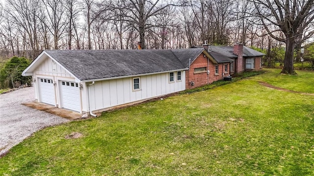 12810 Big Bend Rd, Kirkwood, MO 63122 - view of home's exterior with a shingled roof, board and batten siding, a chimney, a yard, and driveway