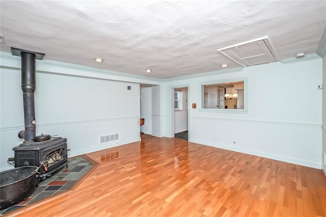12810 Big Bend Rd, Kirkwood, MO 63122 - living room with a wood stove, wood finished floors, recessed lighting, and baseboards