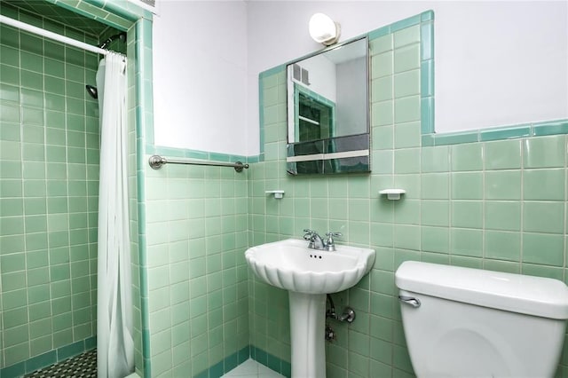 12810 Big Bend Rd, Kirkwood, MO 63122 - bathroom with toilet, a stall shower, and tile walls