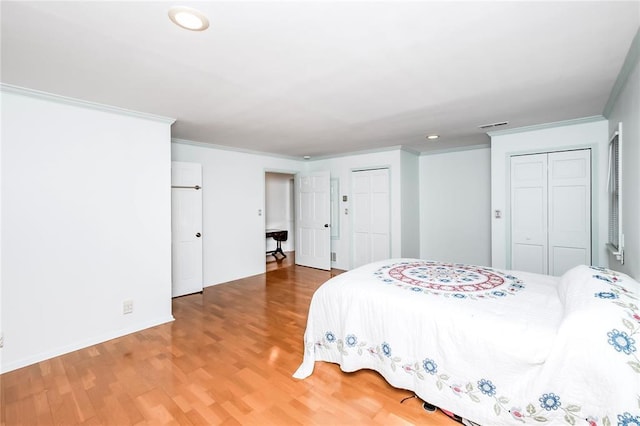 12810 Big Bend Rd, Kirkwood, MO 63122 - bedroom with multiple closets, ornamental molding, wood finished floors, recessed lighting, and baseboards