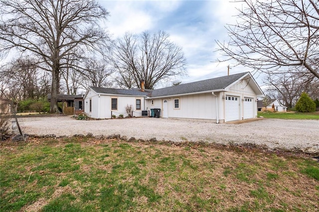 12810 Big Bend Rd, Kirkwood, MO 63122 - back of house with board and batten siding, a chimney, gravel driveway, and cooling unit