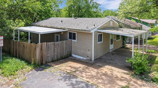 3368 S Suncrest Ave, Saint Louis, MO 63114 - rear view of property with concrete driveway and a shingled roof