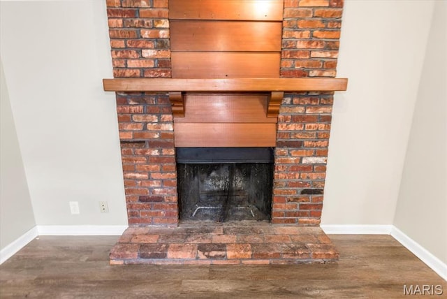 3368 S Suncrest Ave, Saint Louis, MO 63114 - detailed view of a brick fireplace and wood finished floors
