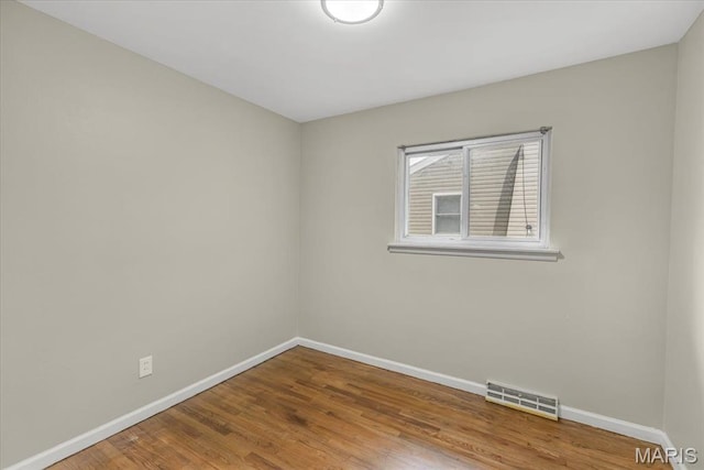 3368 S Suncrest Ave, Saint Louis, MO 63114 - spare room featuring baseboards and wood finished floors