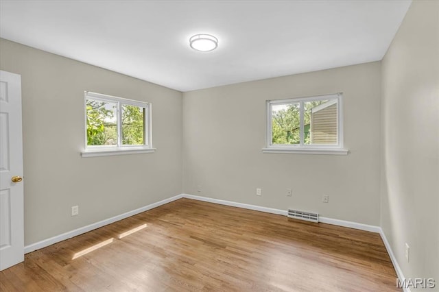 3368 S Suncrest Ave, Saint Louis, MO 63114 - unfurnished room with plenty of natural light and wood finished floors