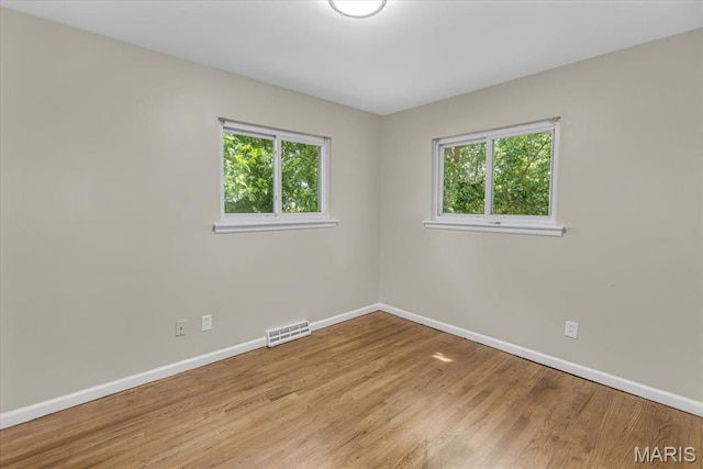 3368 S Suncrest Ave, Saint Louis, MO 63114 - empty room with plenty of natural light and light wood-style floors
