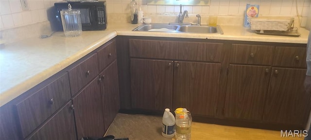 4209 Edgewood Blvd, Normandy, MO 63121 - kitchen with a sink, tasteful backsplash, light countertops, black microwave, and dark brown cabinetry