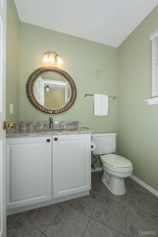 1105 Big Bend Crossing Dr, Manchester, MO 63088 - bathroom featuring vanity, toilet, tile patterned floors, and baseboards