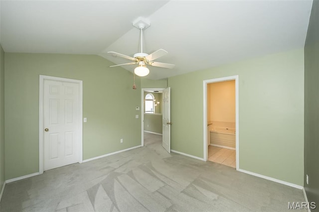 1105 Big Bend Crossing Dr, Manchester, MO 63088 - unfurnished bedroom featuring baseboards, light carpet, lofted ceiling, ceiling fan, and ensuite bath