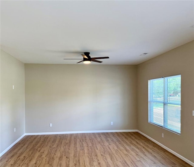 812 Main St, New London, MO 63459 - unfurnished room with wood finished floors, a ceiling fan, and baseboards