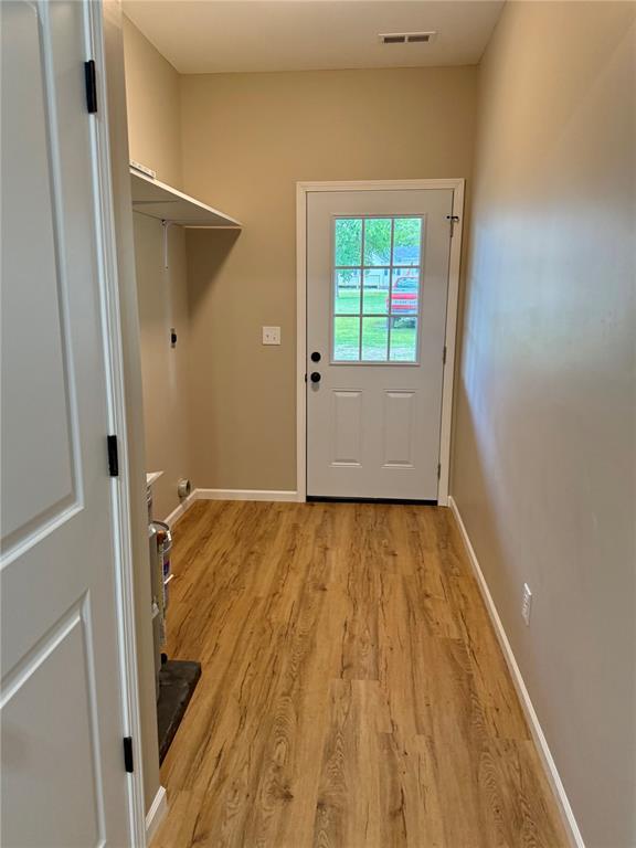 812 Main St, New London, MO 63459 - doorway to outside featuring light wood-style flooring and baseboards