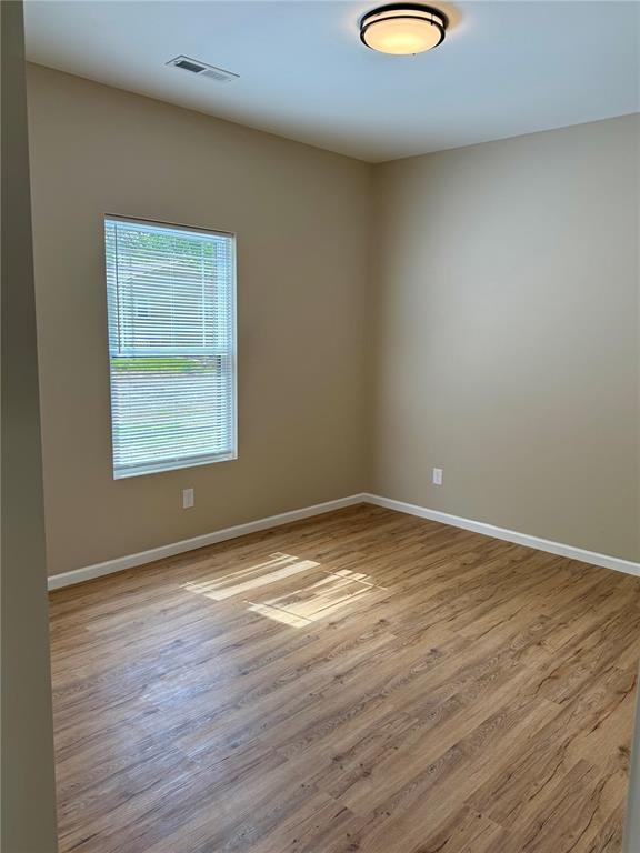 812 Main St, New London, MO 63459 - spare room with wood finished floors and baseboards