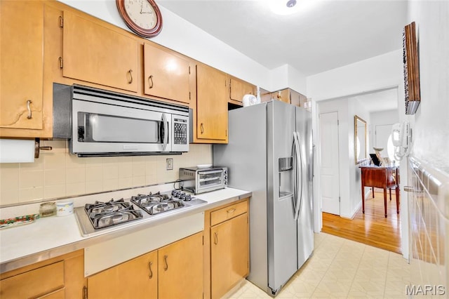 8967 New Sappington Rd, Crestwood, MO 63126 - kitchen featuring appliances with stainless steel finishes, light countertops, and decorative backsplash