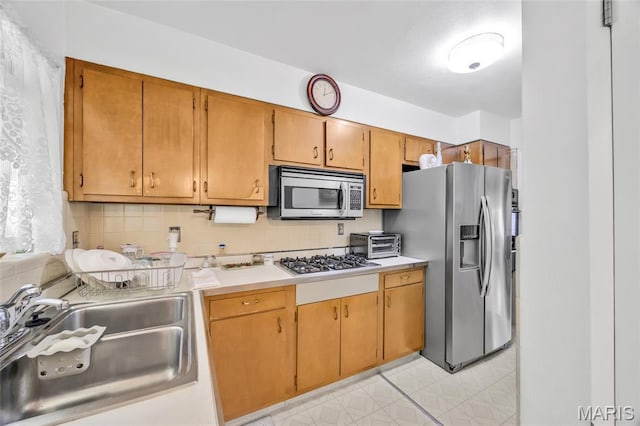 8967 New Sappington Rd, Crestwood, MO 63126 - kitchen with appliances with stainless steel finishes, a sink, light countertops, and decorative backsplash