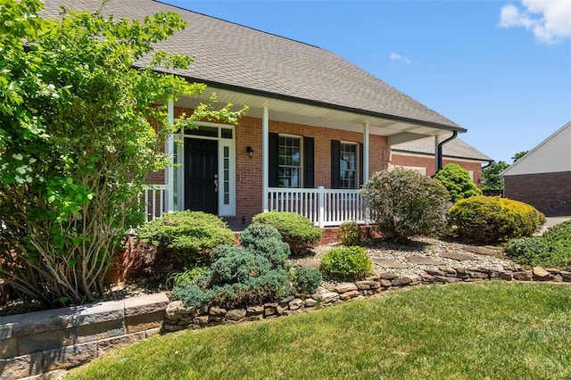 1014 Trailridge Dr, Jackson, MO 63755 - view of front facade with a porch, brick siding, a shingled roof, and a front yard