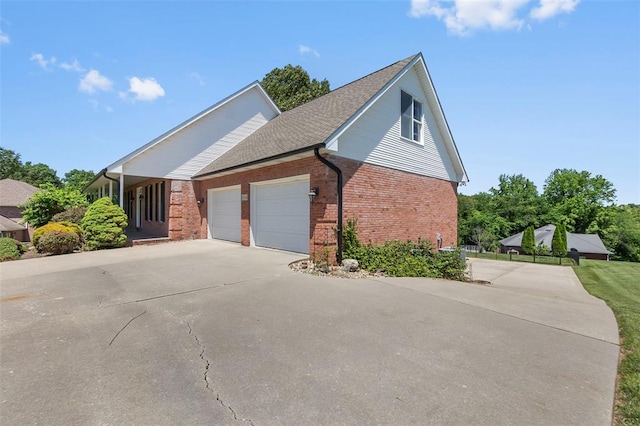1014 Trailridge Dr, Jackson, MO 63755 - view of side of property featuring brick siding, a garage, driveway, and a shingled roof