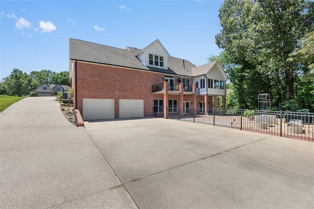 1014 Trailridge Dr, Jackson, MO 63755 - view of front of home featuring driveway, brick siding, a balcony, and a garage