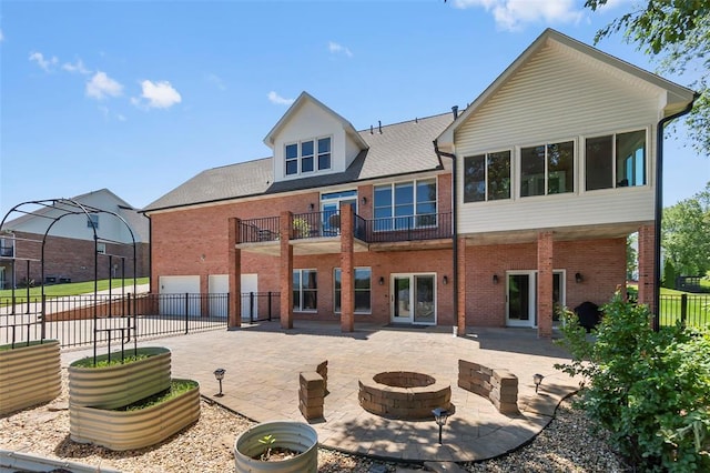 1014 Trailridge Dr, Jackson, MO 63755 - back of property with brick siding, a fire pit, a garage, and a patio area