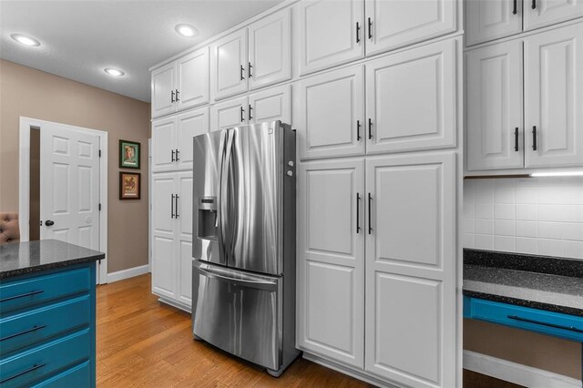 1014 Trailridge Dr, Jackson, MO 63755 - kitchen with stainless steel refrigerator with ice dispenser, white cabinetry, decorative backsplash, recessed lighting, and light wood-style flooring