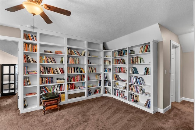 1014 Trailridge Dr, Jackson, MO 63755 - sitting room with carpet flooring, bookshelves, ceiling fan, a textured ceiling, and baseboards
