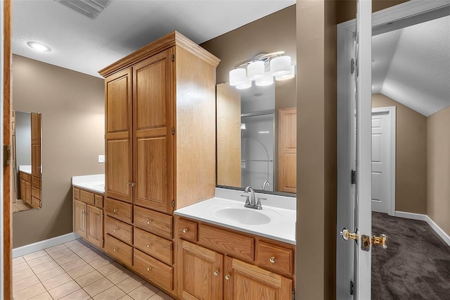 1014 Trailridge Dr, Jackson, MO 63755 - full bath featuring baseboards, double vanity, vaulted ceiling, and tile patterned floors