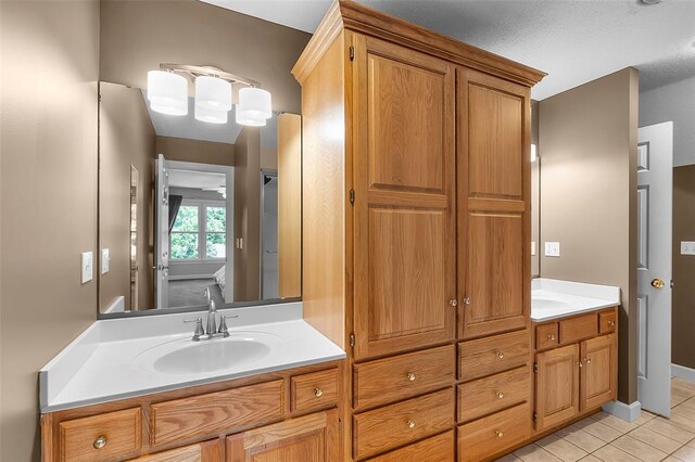 1014 Trailridge Dr, Jackson, MO 63755 - bathroom with double vanity, tile patterned flooring, and baseboards