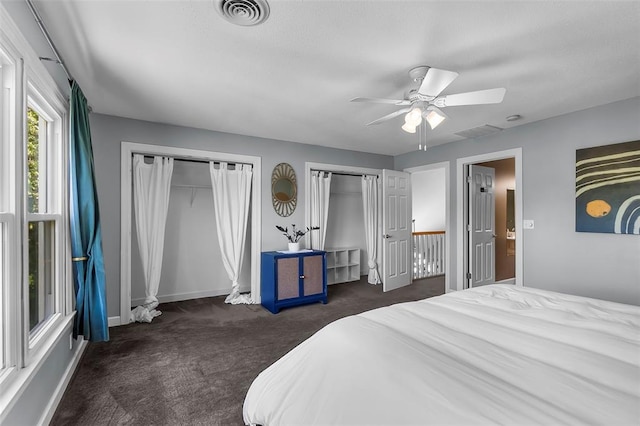 1014 Trailridge Dr, Jackson, MO 63755 - carpeted bedroom with two closets, a ceiling fan, and baseboards