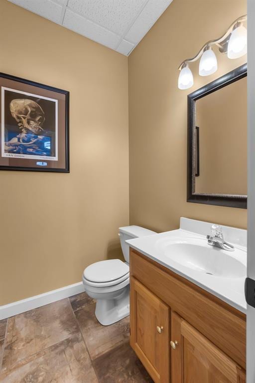 1014 Trailridge Dr, Jackson, MO 63755 - half bathroom featuring a paneled ceiling, toilet, vanity, and baseboards