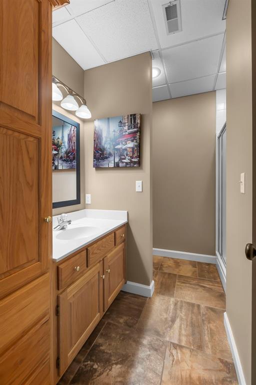 1014 Trailridge Dr, Jackson, MO 63755 - full bathroom with vanity, a paneled ceiling, baseboards, and a shower stall