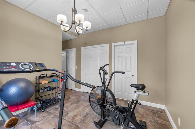 1014 Trailridge Dr, Jackson, MO 63755 - workout room featuring a chandelier, baseboards, and a paneled ceiling
