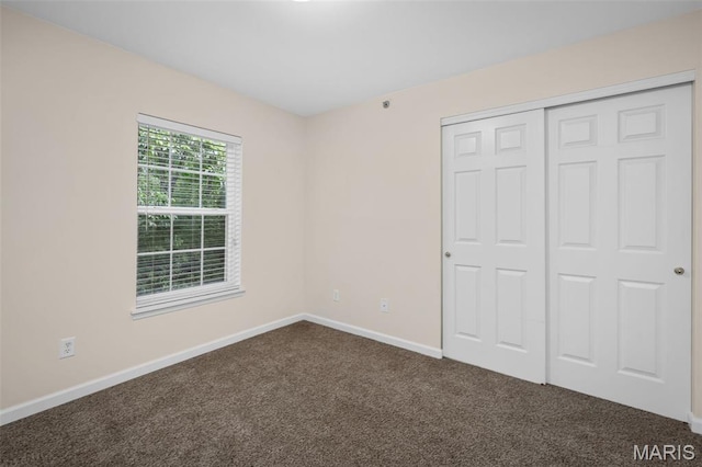 160 Brandy Mill Cir Unit 7C, High Ridge, MO 63049 - unfurnished bedroom featuring dark colored carpet and a closet