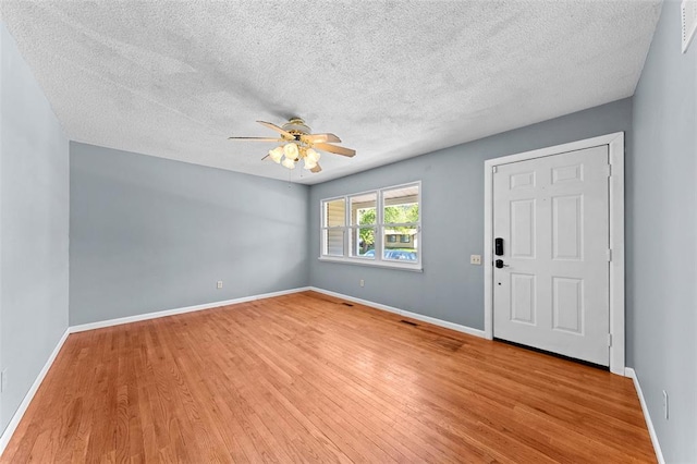 2535 S Park Ln, Florissant, MO 63031 - entrance foyer with a ceiling fan, wood finished floors, a textured ceiling, and baseboards