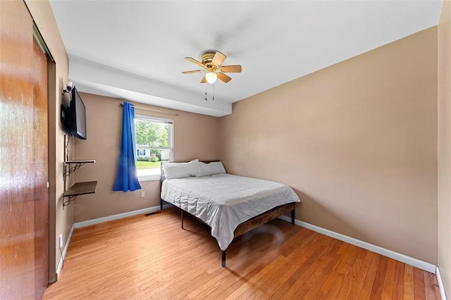 2535 S Park Ln, Florissant, MO 63031 - bedroom with baseboards, light wood-style floors, and ceiling fan