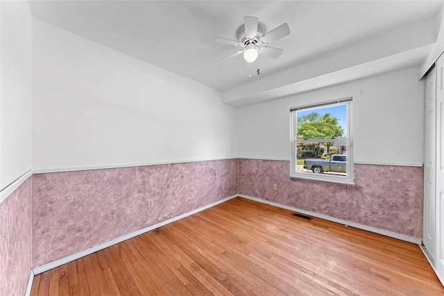 2535 S Park Ln, Florissant, MO 63031 - spare room featuring wainscoting, wood-type flooring, and ceiling fan