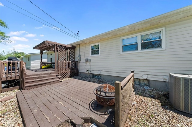 2535 S Park Ln, Florissant, MO 63031 - wooden deck with an outdoor fire pit and central air condition unit