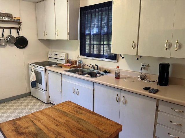 194 Craft Subdivision Rds, Greenville, MO 63944 - kitchen featuring white electric range, a sink, light countertops, and baseboards
