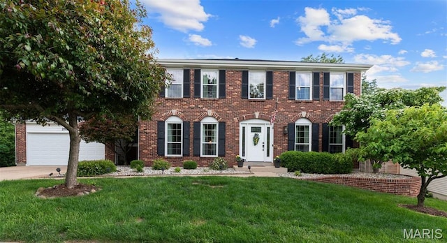 2854 Championship Blvd, Saint Louis, MO 63129 - colonial-style house featuring a front lawn, concrete driveway, and brick siding