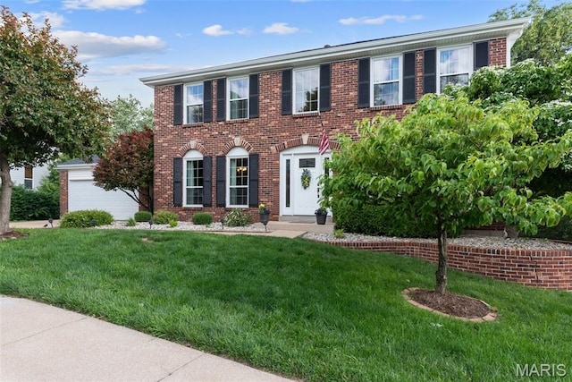 2854 Championship Blvd, Saint Louis, MO 63129 - colonial inspired home with a front lawn and brick siding