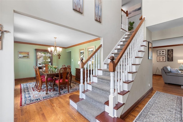 2854 Championship Blvd, Saint Louis, MO 63129 - stairway with wood finished floors, a chandelier, baseboards, and ornamental molding
