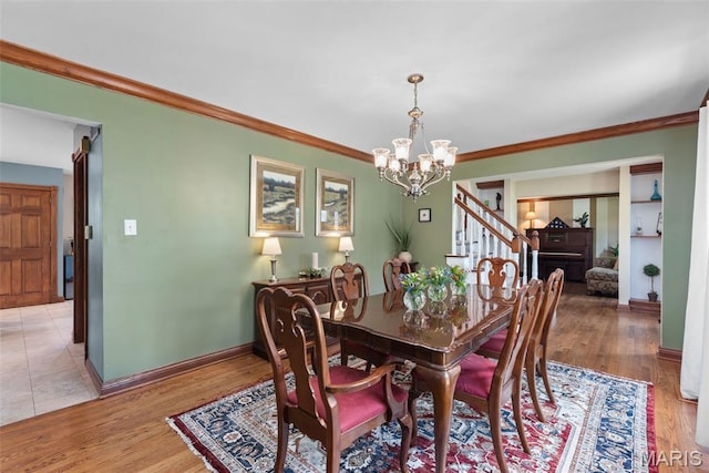 2854 Championship Blvd, Saint Louis, MO 63129 - dining space featuring a chandelier, baseboards, stairs, ornamental molding, and light wood-type flooring