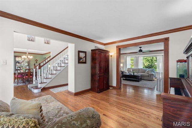 2854 Championship Blvd, Saint Louis, MO 63129 - living room with light wood-style floors, a chandelier, stairs, crown molding, and baseboards
