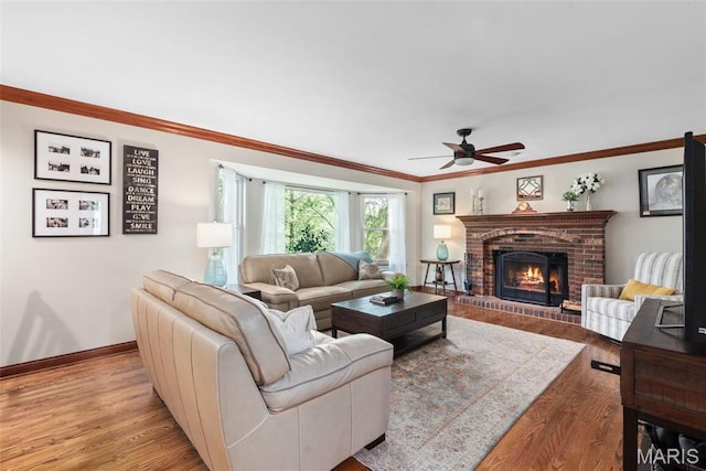 2854 Championship Blvd, Saint Louis, MO 63129 - living area featuring ceiling fan, wood finished floors, a brick fireplace, ornamental molding, and baseboards